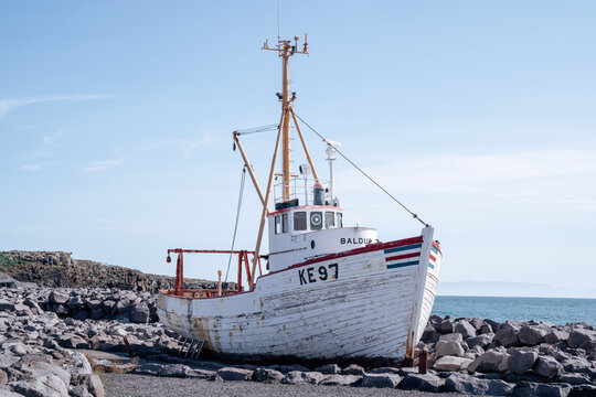 Keflavik, Iceland - July 11, 2023:  The shipwreck fishing boat Baldur (1961) is aground on rocks on a sunny day