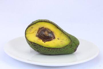 Avocado slices with seeds visible isolated on white background