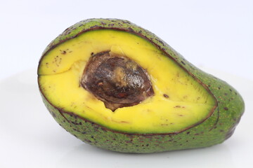 Avocado slices with seeds visible isolated on white background