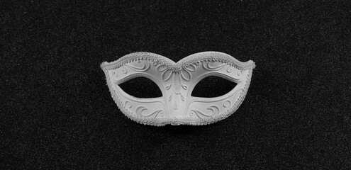 white masquerade eye mask isolated on black background