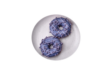 Delicious sweet donut of purple color in glaze and with lilac balls