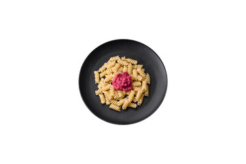 Delicious fusilli pasta with beetroot pesto, parmesan, salt and spices