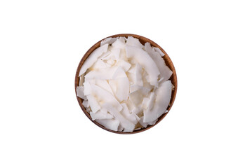 White dry coconut flakes in a wooden bowl prepared for making desserts