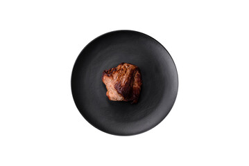Delicious beef steak with salt, spices and herbs on a ceramic plate