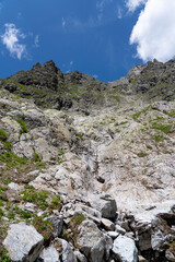 Mountain landscape of switzerland rising up high with a hint blue sky in the background 