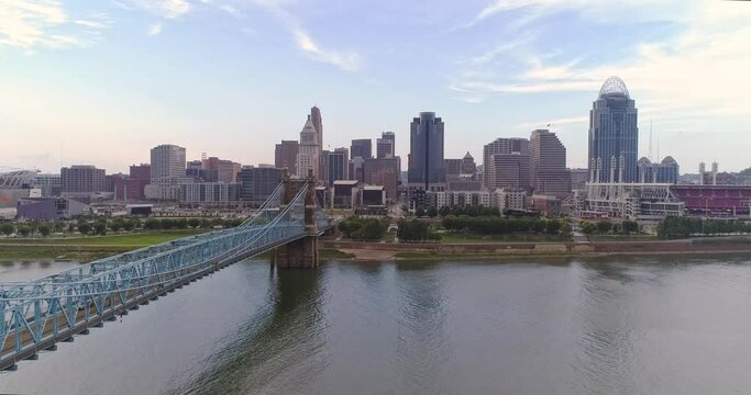 Drone shot of downtown Cincinnati, Ohio skyline, over the suspension bridge on the Ohio River