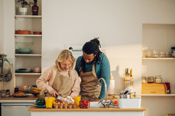 A focused couple is preparing an organic homemade meal at home.