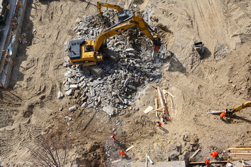 Heavy machinery breaking up Manhattan schist bedrock as construction begins on a high-rise building...