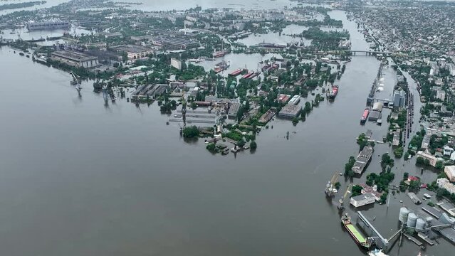 Undermining the dam of the Kakhovka reservoir. Consequences of the dam blowing. Flooded port infrastructure of the city of Kherson. Top view from above, aerial footage. Russian-Ukrainian war