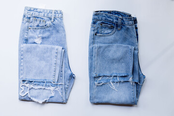 Top view, jeans trouser female on a white background . show front pocket denim in store and...