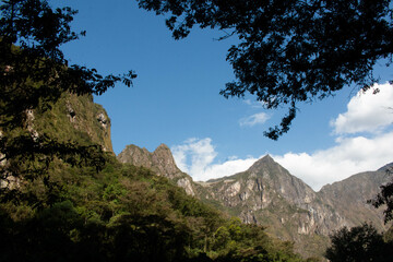 Views of the mountains on the Hidroelectrica road to Aguas Calientes, Machu Picchu village, surrounded by vegetation with sunlight. Peru, Sacred Valley. 