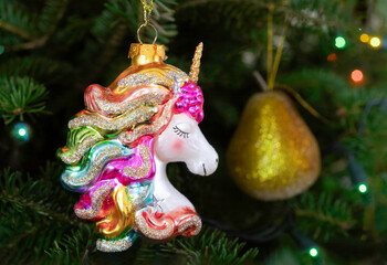 Pretty glass unicorn ornament hanging in the Christmas tree.