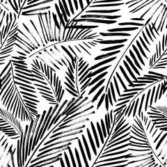 Brush drawn palm leaves seamless pattern. Abstract tropical foliage background. Grunge tropical leaves texture. Foliage ornament with exotic branches. Vector natural seamless pattern. - obrazy, fototapety, plakaty