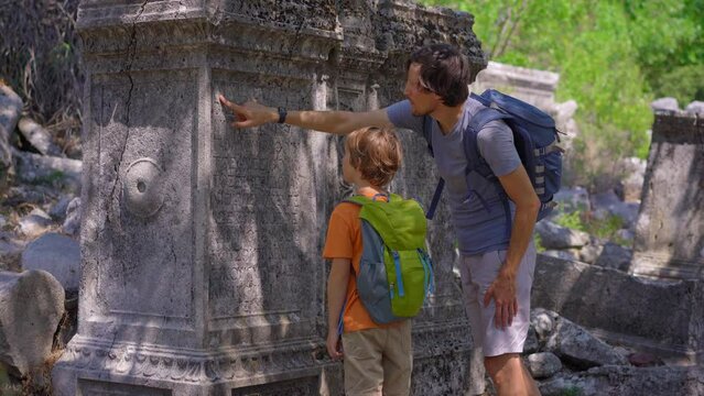A young man and his son embark on a cultural journey as they explore the breathtaking ruins of Termessos, nestled within the mountains near Antalya, Turkey. This footage invites viewers to experience