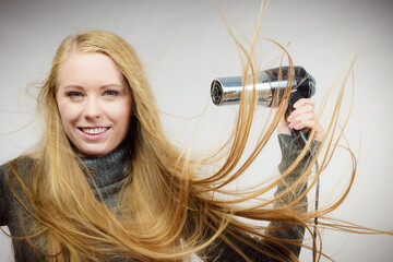 Woman styling her long hair