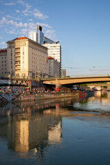 Fototapeta na wymiar Multi-storey buildings on the Danube Canal embankment in Vienna