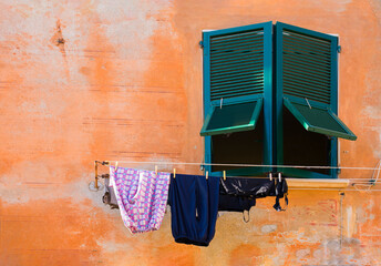 Laundry dries on a clothesline outside a window in Vernazza, one of five ancient, picturesque villages that make up Cinque Terre on Italy's rugged Ligurian coast
