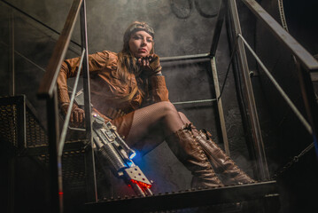 Post apocalyptic girl with the futuristic pump action shotgun on the abandoned building concept...