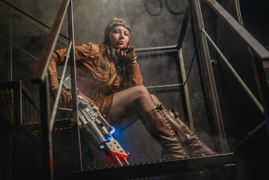 Post apocalyptic girl with the futuristic pump action shotgun on the abandoned building concept background.