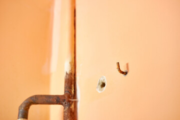 The hook is screwed into the wall. Construction works. House repair.