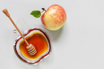 Apple and honey. Concept for Rosh Hashanah the Jewish New Year. Close up on light blue background. Top view, close up, flat lay