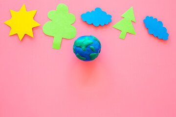 Plasticine globe planet Earth with childs paper clippings - protection ecology concept