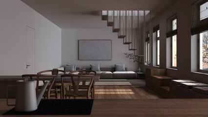 Dark late evening scene, kitchen work top with induction hob and teapot close up. Nordic living and dining room. Sofa and staircase. Minimal interior design