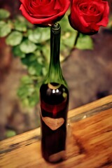 A Bottle Of Wine With Two Roses In It