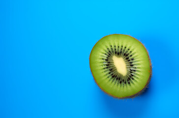 half Kiwi fruit on a blue and light blue background
