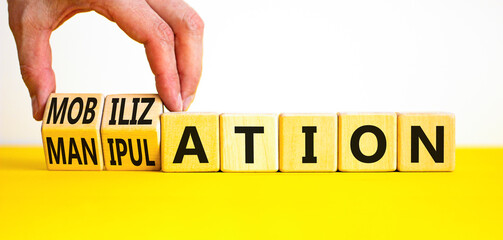 Mobilization or manipulation symbol. Concept words Mobilization Manipulation on wooden cubes. Beautiful white background. Psychologist hand. Psychology mobilization manipulation concept. Copy space.