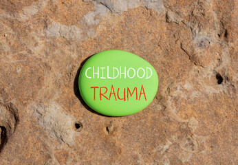 Childhood trauma symbol. Concept words Childhood trauma on beautiful big green stone. Beautiful...