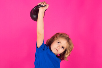 Studio isolated portrait of sporty child. Kids sports exercises. Healthy kids life and sport concept. Portrait of child boy working out with dumbbells. Motivation and sport concept for children.