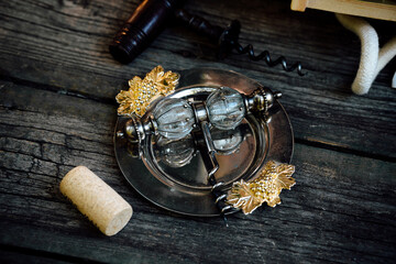 Elegant Wine Corkscrew with Grape Leaf Ornament and Cork on Wooden Table – Vintage Wine Tasting Still Life