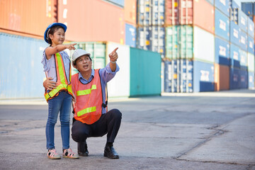 engineer or factory worker with her niece looking forward and pointing up to something in...