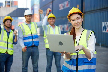 factory worker or engineer working on laptop computer in containers warehouse storage