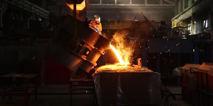Liquid iron molten metal pouring in container, industrial metallurgical factory, foundry cast, heavy industry background