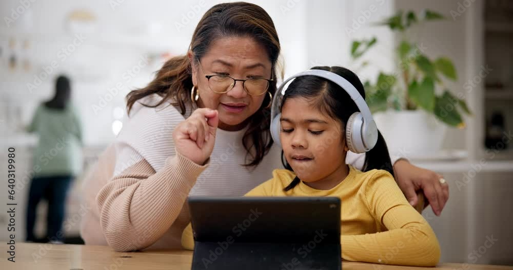 Wall mural Tablet, education and a girl learning with her grandma in the home living room during a family visit. Technology, study or homework with a senior woman teaching her granddaughter in a house together