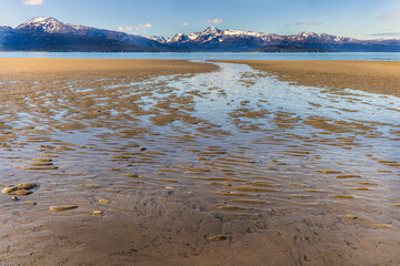 Beach with mountains in background, Homer, Alaska.