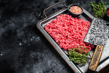 Raw Forcemeat , Mince Ground beef and pork in a kitchen tray. Black background. Top view. Copy space