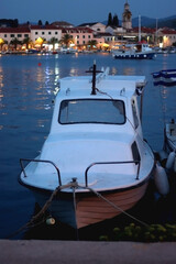 Naklejka premium Small boat moored in Vela Luka, on island Korcula, Croatia. Selective focus, blue evening light.