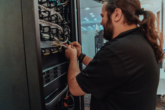 Close up of technician setting up network in server room 