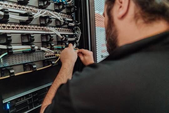 Close up of technician setting up network in server room 