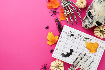 Start getting into the Halloween mood. Top view photo of calendar, spooky skull, skeleton hands,...