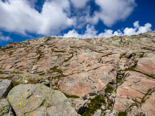 Close up view of red marble rock formation in Mercantour National Park in the Valley of Marvels near Tende, Provence-Alpes-Côte d'Azur Alpes-Maritimes, France. Sedimentary unique layers of rocks