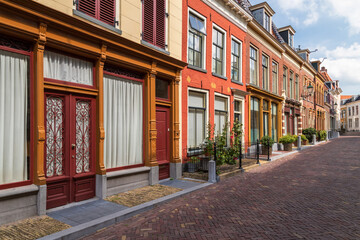 Narrow street with historic houses and beautiful facades in the center of the city of Leeuwarden in Friesland.