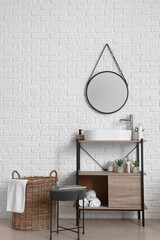 Interior of stylish bathroom with dressing table, sink and mirror