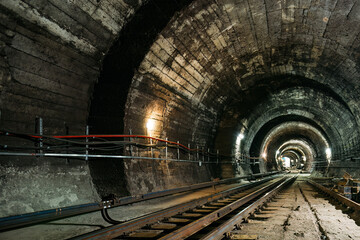 Round underground subway tunnel with tubing - obrazy, fototapety, plakaty