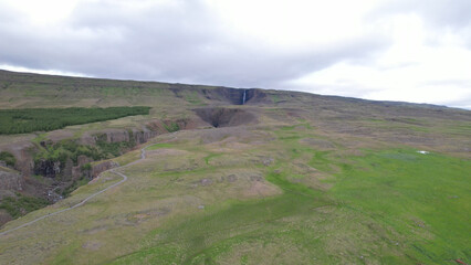 AERIAL VIEW Hengifoss is a waterfall that runs from the river Hengifossá in the municipality of Fljótsdalshreppur in East Iceland. At 128 meters (420 feet) it is the third tallest waterfall in Iceland