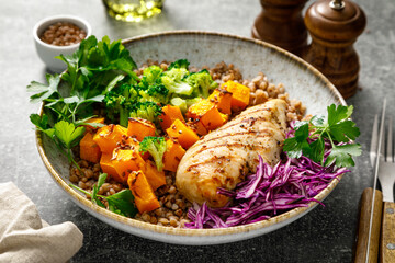 Grilled chicken breast with buckwheat, roasted butternut squash, broccoli, fresh greens and red...