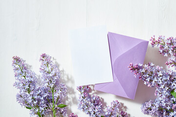 Mockup white greeting card and envelope with lilac branches on a white background